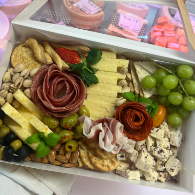 Small Grazing Box - A perfect treat-for-two featuring sliced cheeses, cured meats, olives, crackers, nuts, grapes, and a touch of sweetness. All boxed and ready to impress.